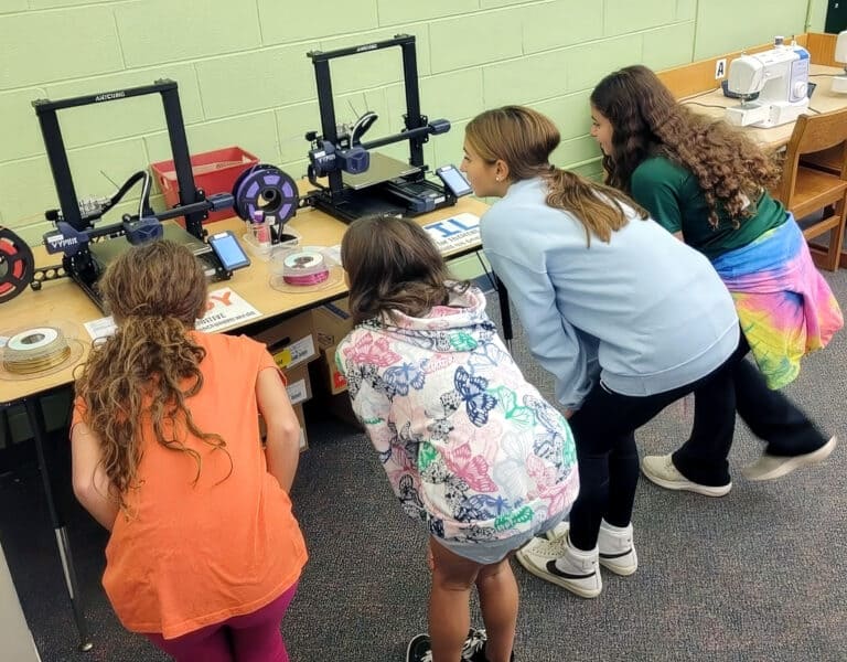 Students at Midland Park Public Education Foundation explore 3D printers and filament spools.